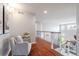 Upstairs hallway with hardwood floors, a sitting area, and a view of the staircase at 13804 Quail Ridge Dr, Broomfield, CO 80020