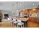 Open kitchen featuring an island with seating, granite countertops, and stainless steel appliances at 13804 Quail Ridge Dr, Broomfield, CO 80020