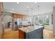 Bright kitchen featuring wood cabinets, stainless steel appliances, granite countertops, and an island with seating at 13804 Quail Ridge Dr, Broomfield, CO 80020