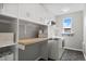 Well-organized laundry room with ample storage, a folding counter, and modern appliances at 13804 Quail Ridge Dr, Broomfield, CO 80020