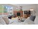 Cozy living room with a brick fireplace, ample seating, and a large window with a view at 13804 Quail Ridge Dr, Broomfield, CO 80020