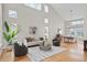 Spacious living room featuring tall windows, natural light, vaulted ceilings, and hardwood floors at 13804 Quail Ridge Dr, Broomfield, CO 80020