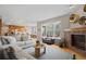 Spacious living room with a fireplace, large window, and open access to the kitchen and dining area at 13804 Quail Ridge Dr, Broomfield, CO 80020