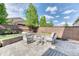 Relaxing backyard fire pit area with paved patio, comfortable seating, and mature trees at 15389 W 50Th Dr, Golden, CO 80403