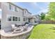 Large backyard features an outdoor seating area with fire pit, spacious lawn, and covered patio at 15389 W 50Th Dr, Golden, CO 80403