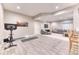 Spacious basement area featuring a lounge space, workout area with weights, and durable wood-look flooring at 15389 W 50Th Dr, Golden, CO 80403
