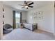 This bedroom offers a minimalist design, a ceiling fan, and natural light from the exterior window at 15389 W 50Th Dr, Golden, CO 80403