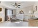 The Bedroom showcases a crib, an armchair, a ceiling fan, and natural light from the exterior window at 15389 W 50Th Dr, Golden, CO 80403