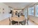 Bright dining area adjacent to an open kitchen with great natural light from the large windows at 15389 W 50Th Dr, Golden, CO 80403