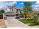 Charming two-story home featuring a manicured lawn and attached two-car garage at 15389 W 50Th Dr, Golden, CO 80403
