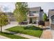Inviting two-story home with stone accents, a well-manicured lawn, and a charming front porch at 15389 W 50Th Dr, Golden, CO 80403