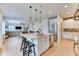 Bright, open kitchen with a large island, pendant lighting, and stainless steel appliances at 15389 W 50Th Dr, Golden, CO 80403