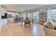 Open-concept living room with dining area, hardwood floors, and a modern kitchen at 15389 W 50Th Dr, Golden, CO 80403