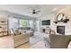 Comfortable living room featuring a fireplace and large windows for natural light at 15389 W 50Th Dr, Golden, CO 80403