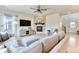 Cozy living room featuring a stone fireplace, ceiling fan, and hardwood floors at 15389 W 50Th Dr, Golden, CO 80403