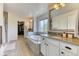 An elegant bathroom with a soaking tub, dual sink vanity, tile floors, and a separate walk-in closet at 15389 W 50Th Dr, Golden, CO 80403