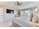 Bright main bedroom showcases a vaulted ceiling, a ceiling fan, plush carpeting, and exterior views from the windows at 15389 W 50Th Dr, Golden, CO 80403