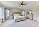 This main bedroom features neutral décor, a ceiling fan, and plentiful natural light from two windows at 15389 W 50Th Dr, Golden, CO 80403