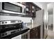 Modern kitchen design featuring stainless steel appliances, granite countertops, and dark wood cabinets at 1020 15Th St # 9N, Denver, CO 80202
