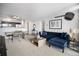 Bright living room with modern blue sofa, stylish decor and a glimpse of the open kitchen at 1020 15Th St # 9N, Denver, CO 80202