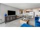 Open floor plan shows a large television, dining area, modern kitchen and blue sofa at 1020 15Th St # 9N, Denver, CO 80202