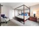 Comfortable bedroom featuring a four-poster bed, accent chair and modern nightstands at 1020 15Th St # 9N, Denver, CO 80202