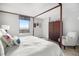 Serene bedroom with a four-poster bed, closet, chair and scenic city views at 1020 15Th St # 9N, Denver, CO 80202