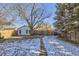 Large backyard with snow-covered lawn and wooden fence at 4336 Thompson Ct, Denver, CO 80216