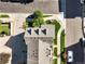 An aerial view shows the roof of a house with a backyard featuring a cozy fire pit and greenery at 10241 Bellwether Ln, Lone Tree, CO 80124