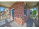 Balcony with brick wall, wooden decking, and views of greenery and a neighboring building at 10241 Bellwether Ln, Lone Tree, CO 80124