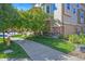 Charming townhome features well-kept lawn, mature trees, brick accents, and an attached garage at 10241 Bellwether Ln, Lone Tree, CO 80124