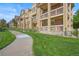 Street-level view of a row of townhouses, each featuring balconies, brick accents, and landscaped walkways at 10241 Bellwether Ln, Lone Tree, CO 80124