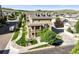 Beautiful multi-story home featuring brick accents, multiple balconies, landscaped yard, and inviting outdoor fire pit at 10241 Bellwether Ln, Lone Tree, CO 80124