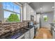 Beautiful kitchen with granite counters, white cabinetry, stainless appliances and tiled backsplash at 10241 Bellwether Ln, Lone Tree, CO 80124