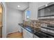 Modern kitchen with stainless steel appliances, granite countertops, and tiled backsplash at 10241 Bellwether Ln, Lone Tree, CO 80124