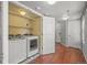 Laundry room with wood floors, washer and dryer, and additional storage space at 10241 Bellwether Ln, Lone Tree, CO 80124