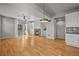 Open-concept living area boasts hardwood floors, a modern fireplace, and convenient access to the balcony at 10241 Bellwether Ln, Lone Tree, CO 80124