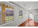 Bright living room with hardwood floors, windows, and walk-out porch at 10241 Bellwether Ln, Lone Tree, CO 80124