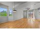 Bright and airy living room with gleaming hardwood floors, large windows, and access to outdoor balcony at 10241 Bellwether Ln, Lone Tree, CO 80124