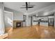 Spacious living room featuring a fireplace, built-in shelving, hardwood flooring, and stylish ceiling fan at 10241 Bellwether Ln, Lone Tree, CO 80124