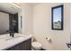 Contemporary bathroom with a single vanity, modern fixtures, and a window offering natural light at 1660 Utica St, Denver, CO 80204