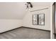 Bright bedroom with plush carpeting, modern lighting and a large window offering natural light at 1660 Utica St, Denver, CO 80204