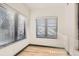 Bright bedroom with wood floors and two large windows offers ample natural light at 1660 Utica St, Denver, CO 80204