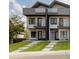 Modern townhome featuring a contemporary design, private balconies, and a well-manicured front lawn at 1660 Utica St, Denver, CO 80204
