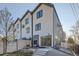 Rear exterior view of the townhome featuring backyard patio with an outdoor seating area and modern siding at 1660 Utica St, Denver, CO 80204