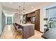 Open-concept kitchen with a center island, seating, modern lighting, and stainless steel appliances at 1660 Utica St, Denver, CO 80204
