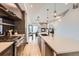 Kitchen featuring a large island, modern appliances, and an open layout with view to the living and dining areas at 1660 Utica St, Denver, CO 80204