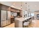 Spacious kitchen featuring stainless steel appliances, a large island with seating, and modern pendant lighting at 1660 Utica St, Denver, CO 80204