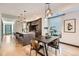 Modern kitchen and dining area featuring an island with seating, pendant lights, and sleek cabinetry at 1660 Utica St, Denver, CO 80204