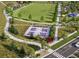 Aerial view of the community park featuring pickleball courts, an expansive lawn, playground, and pedestrian walkways at 6570 Parterre N Pkwy # 2, Thornton, CO 80602